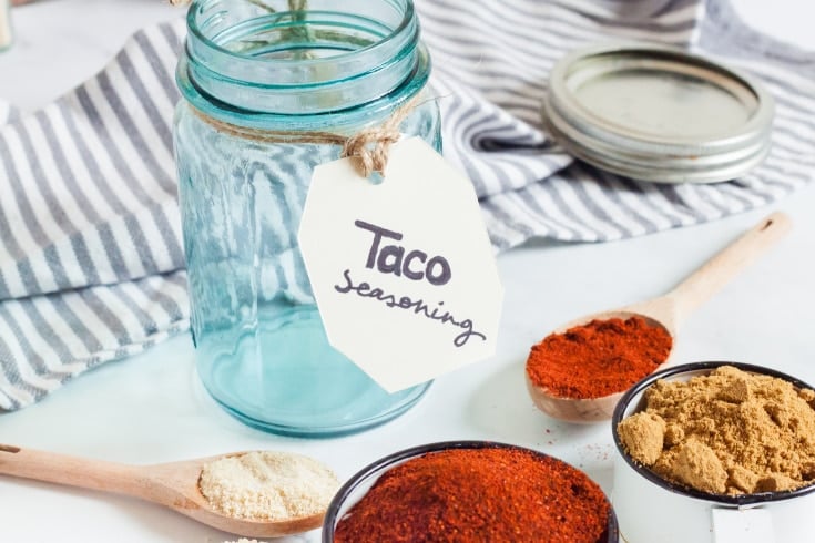 different keto taco spices in wooden spoons with mason jar