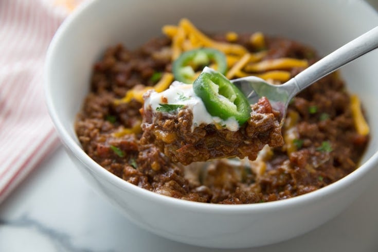 keto chili in a white bowl with a bite on a spoon
