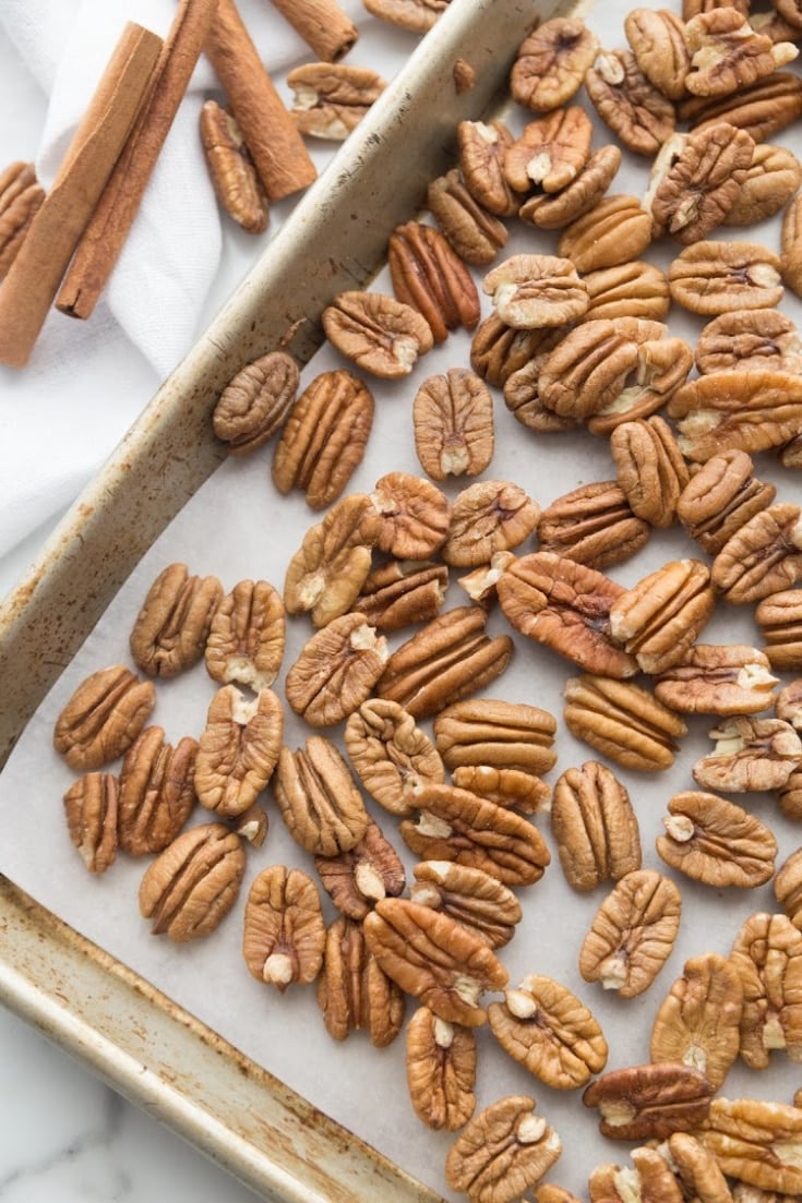 raw pecans on a baking sheet to roast