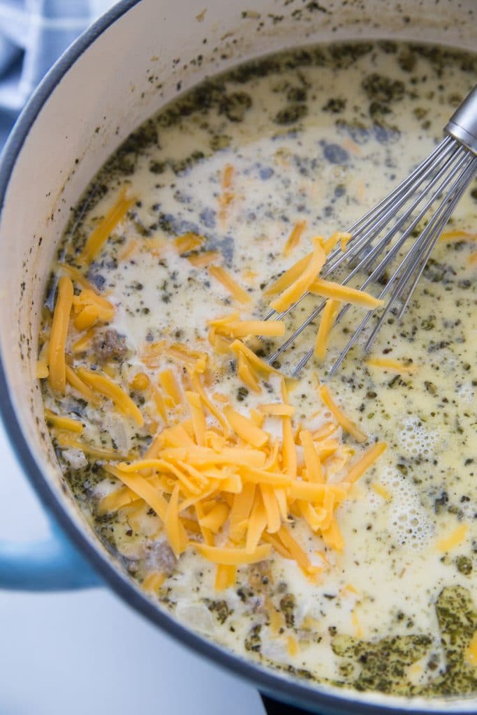 Stirring cheese into the low carb cheeseburger soup
