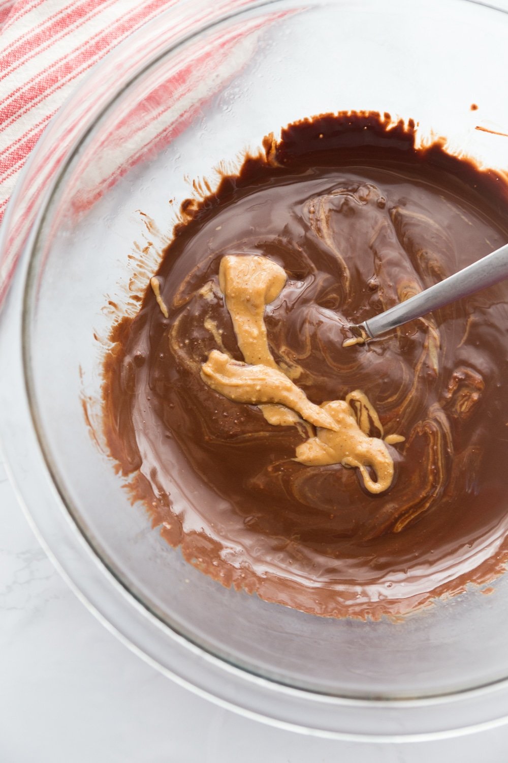 melted sugar free chocolate and natural peanut butter in a clear bowl
