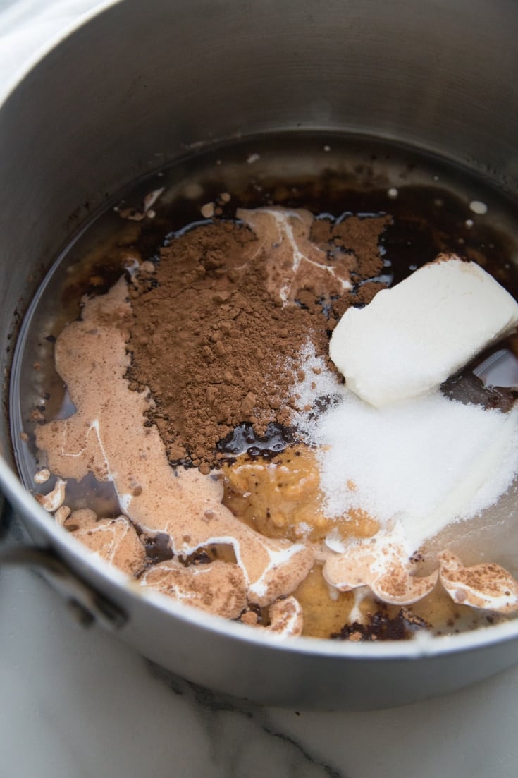 coconut, cocoa powder, peanut butter, walnuts, cream and cream cheese in a bowl