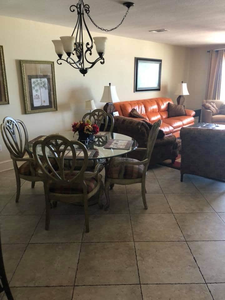 photo of dining area and couch in beach condo