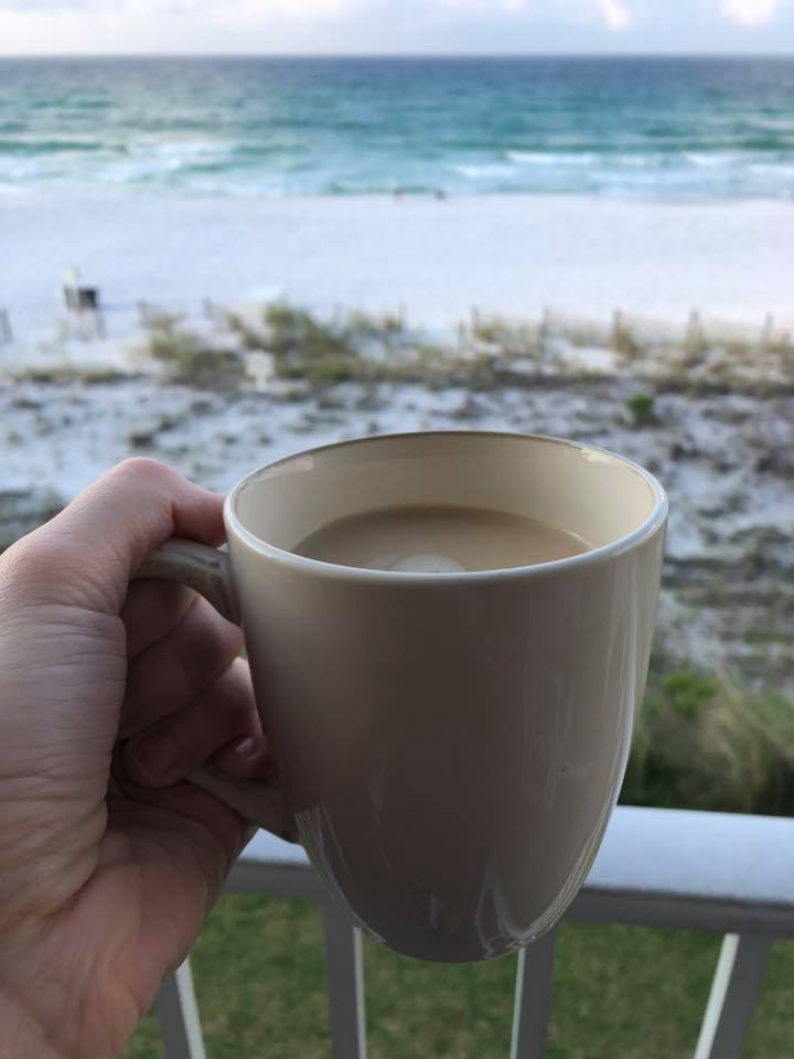 picture of coffee cup on balcony overlooking beach