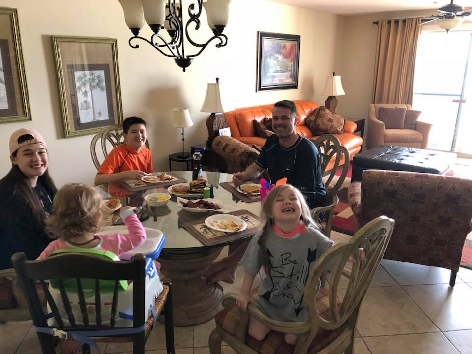 family eating around table 