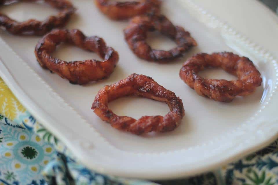 Keto Bacon Wrapped Onion Rings on a white dish 