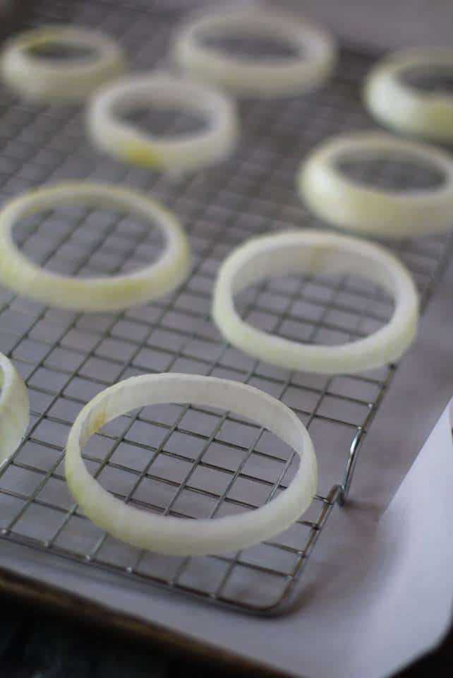 slices of onion on a baking rack