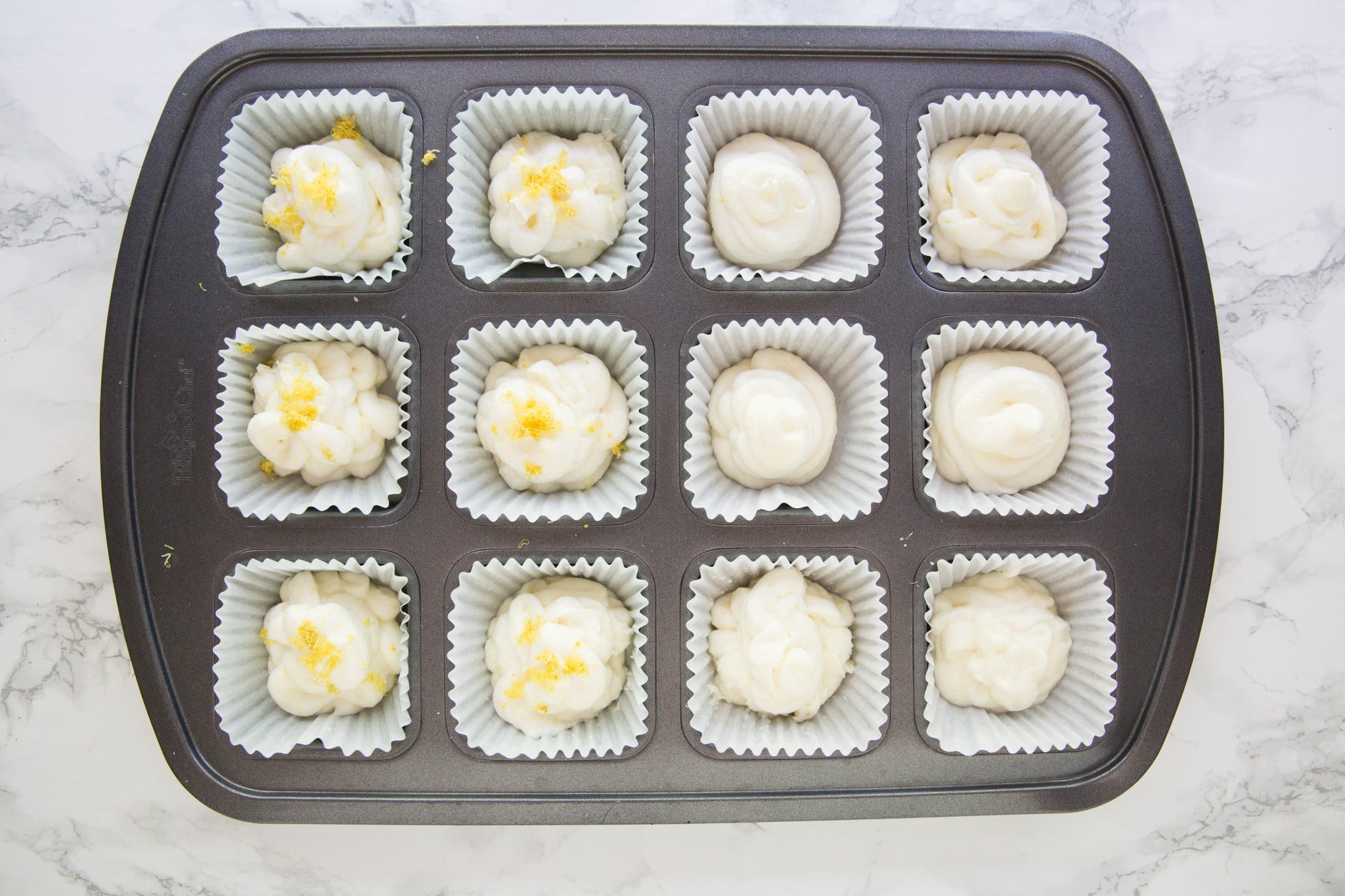 Lemon keto bombs in muffin tin with garnish
