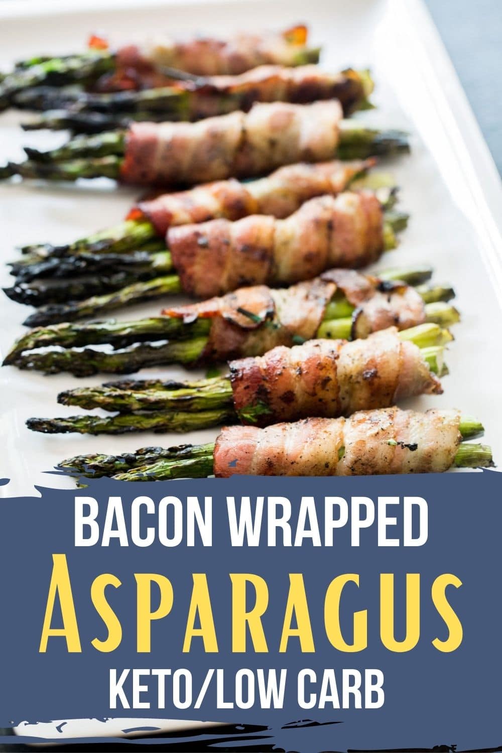 Bacon wrapped asparagus on a white plate