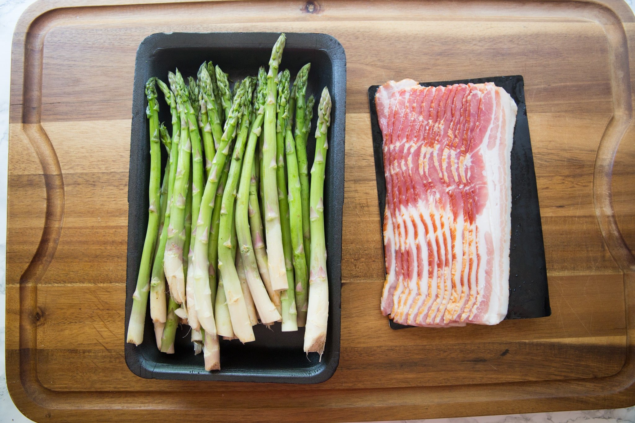 asparagus and bacon on a cutting board