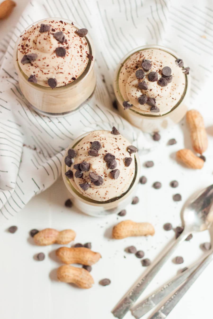 overhead shot of peanut butter keto mousse in jars with chocolate chips