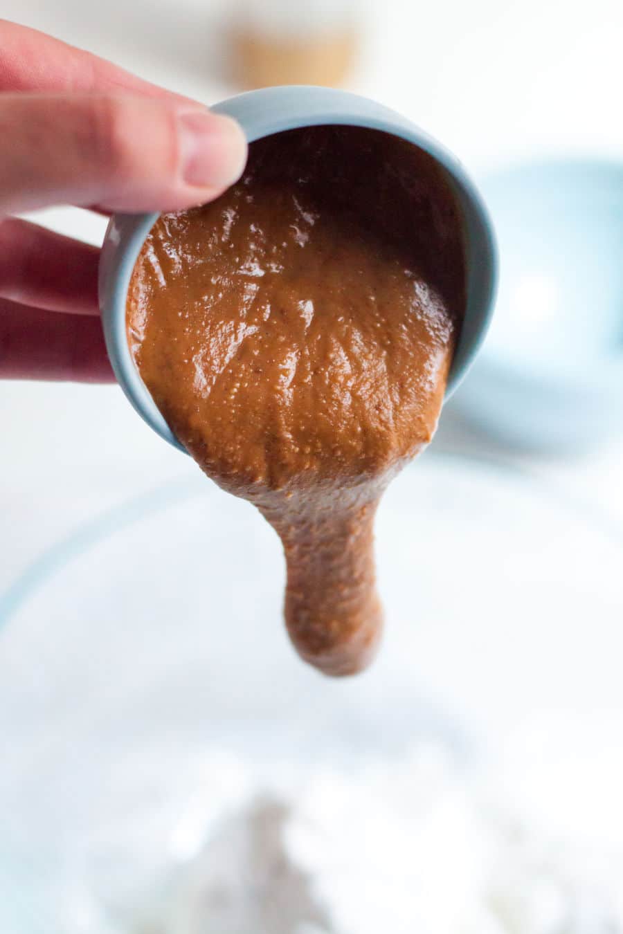 all natural peanut butter being poured into a bowl