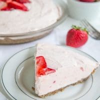 keto strawberry pie on a white plate with pie plate in background