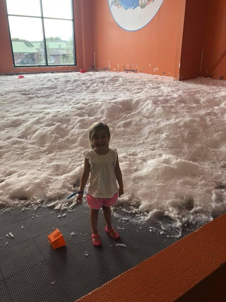 little girl in front of fake snow