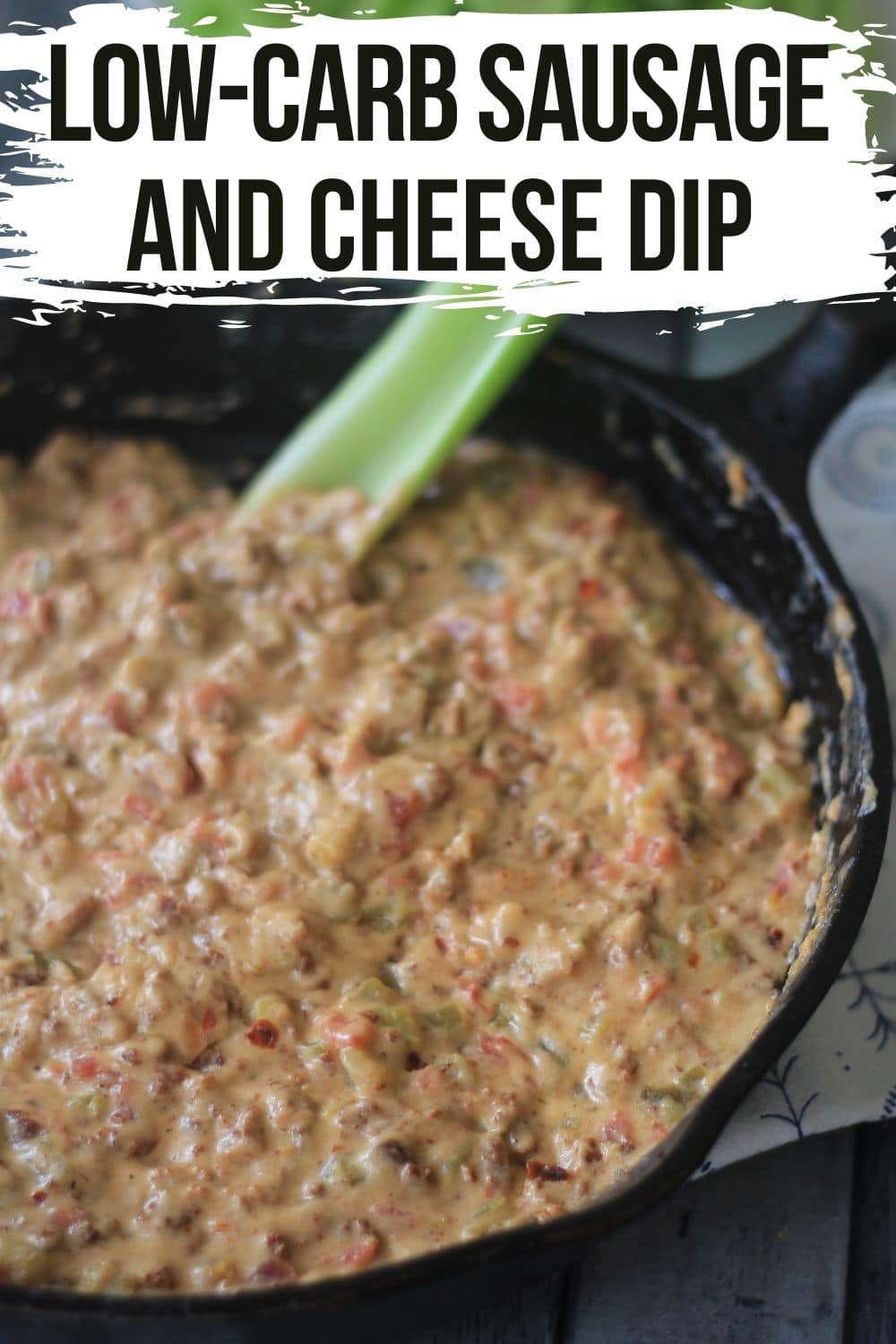 keto sausage dip with cheese in a cast iron skillet