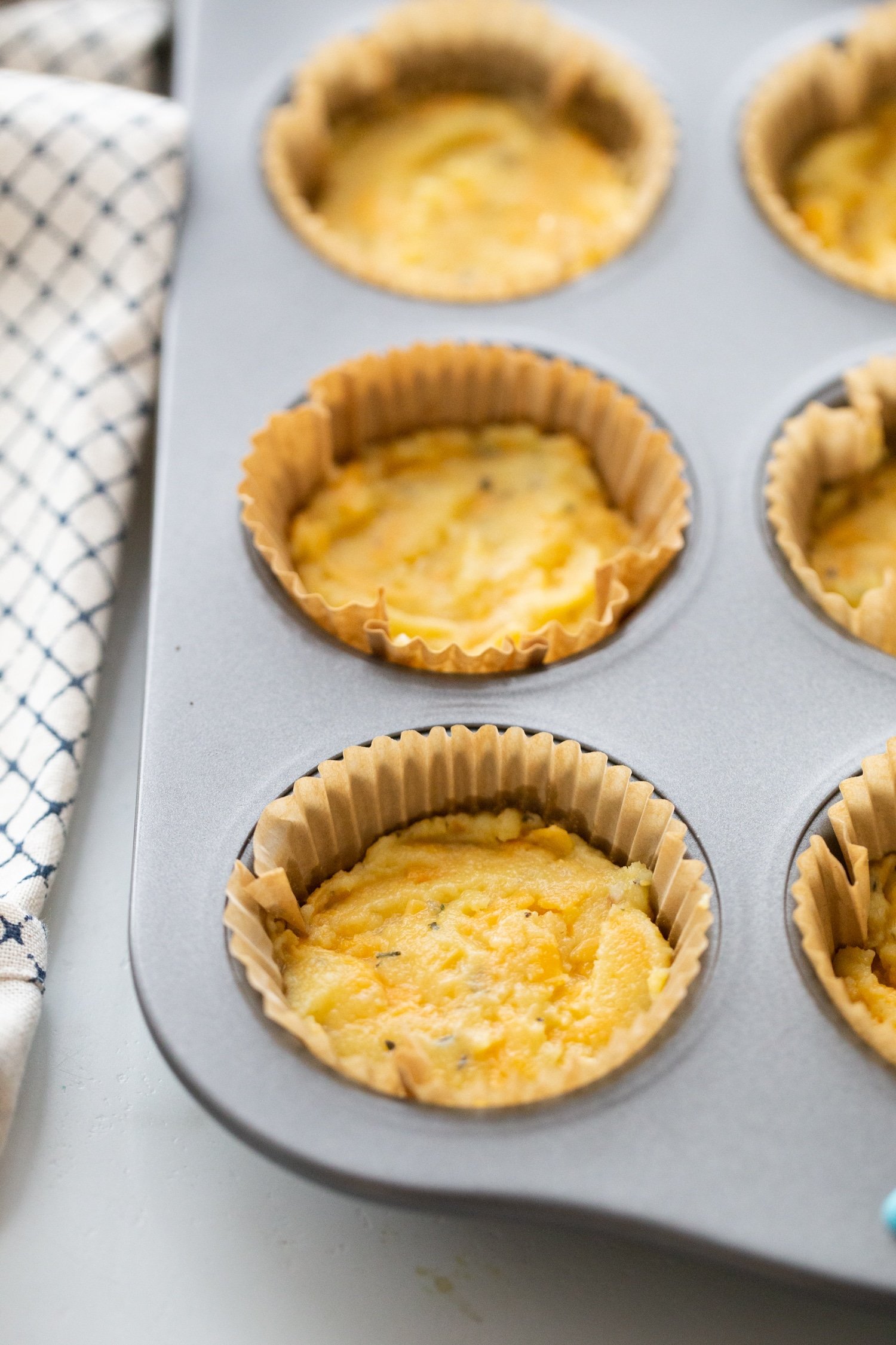 cheddar cheese keto biscuit dough in a muffin tin