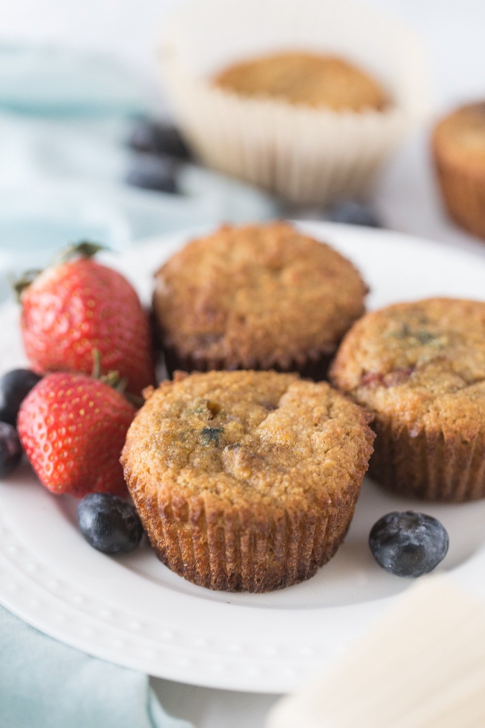 a group of mixed berry muffins and berries
