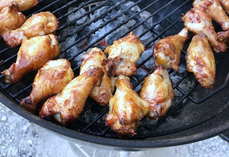 chicken wings cooking on grill