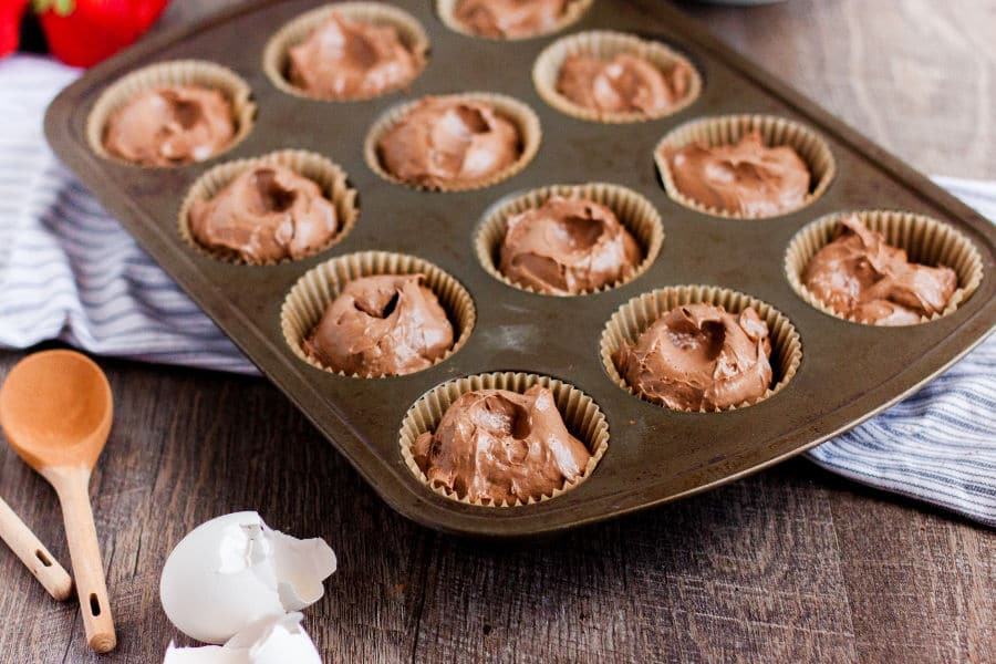 chocolate cheesecake batter in muffin tins