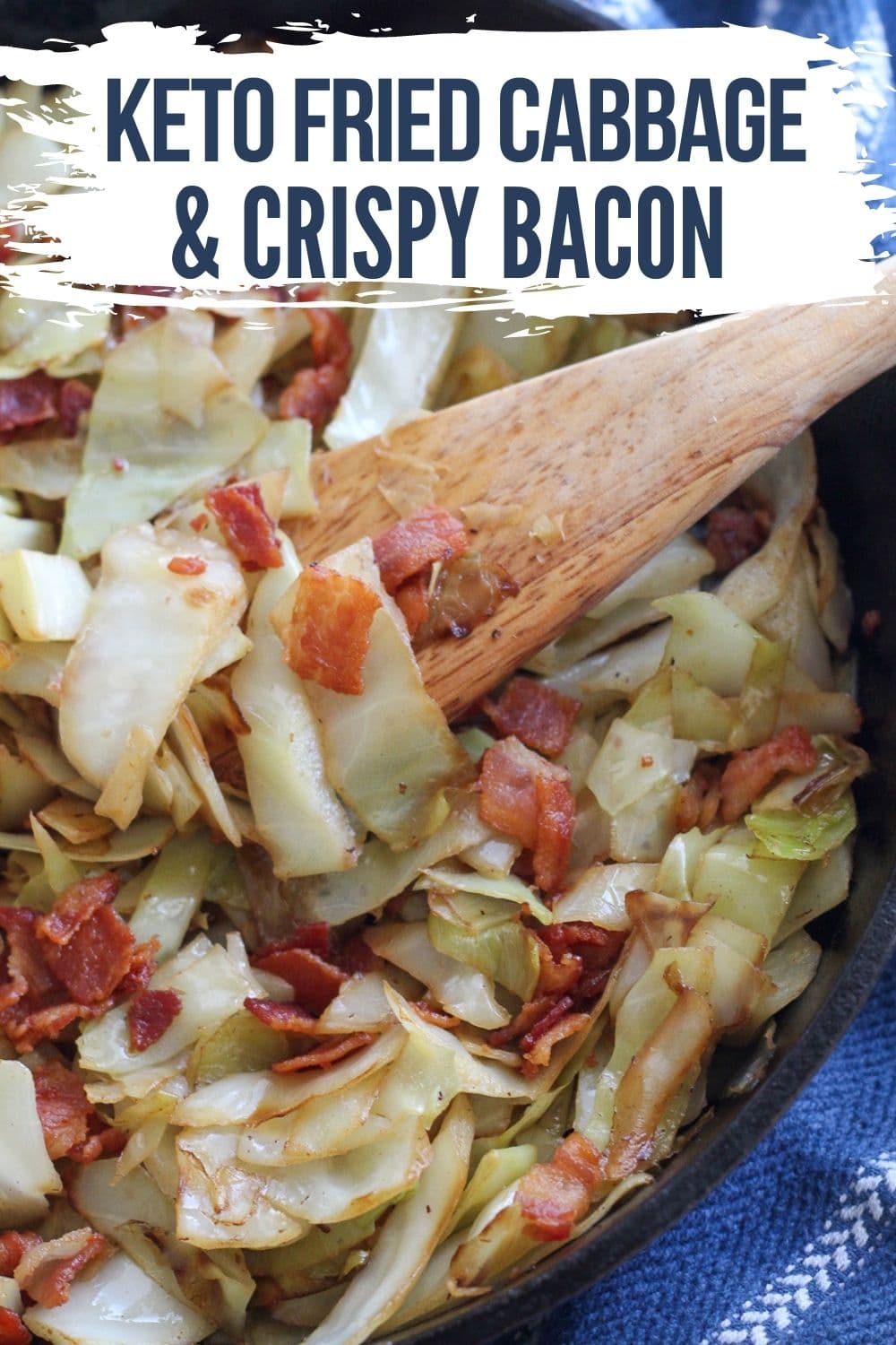 FRIED CABBAGE IN A SKILLET WITH A WOODEN SPOON