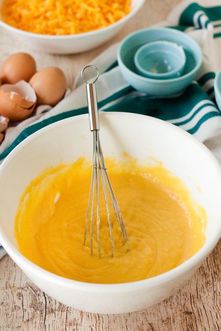 white mixing bowl with melted butter and eggs