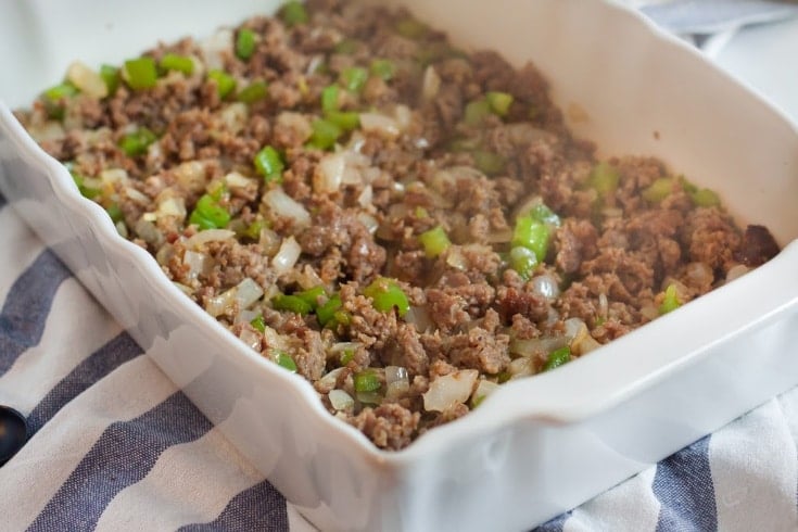 browned sausage with onions and green peppers in the bottom of a casserole dish for low carb breakfast casserole
