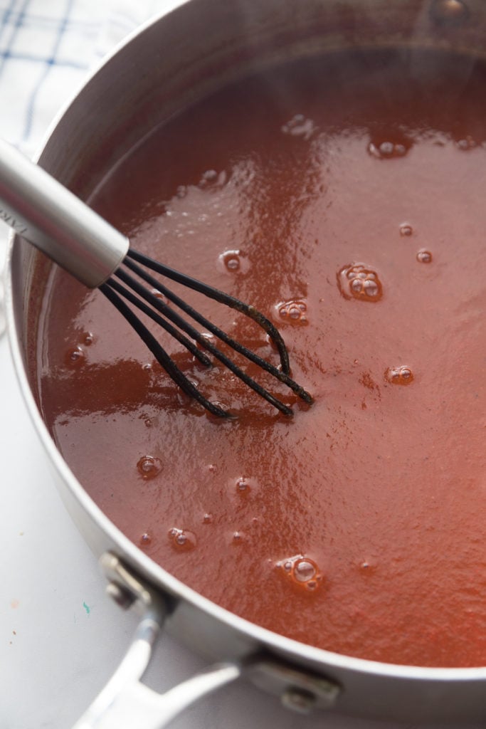 sugar free bbq sauce with a whisk in the pot