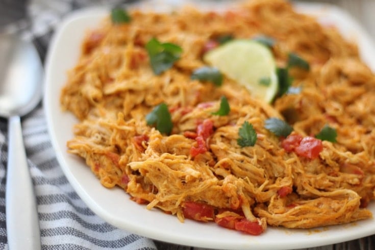 platter of low carb mexican shredded chicken with a lime on top and cilantro