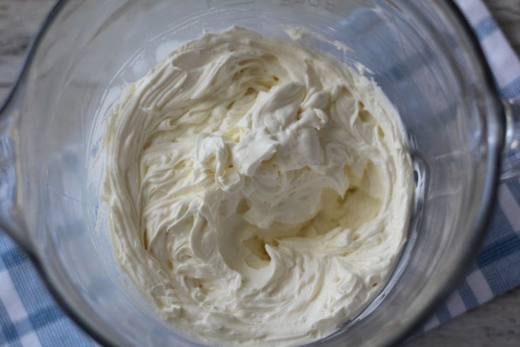 Cream cheese softened and creamed in glass bowl.