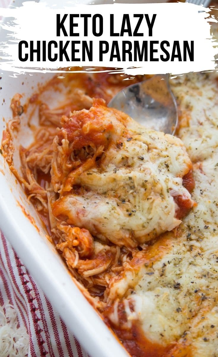 Healthy Chicken Parmesan in a casserole dish with a spoon 