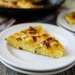 Keto Quiche Recipe on white plate with a black skillet in the background