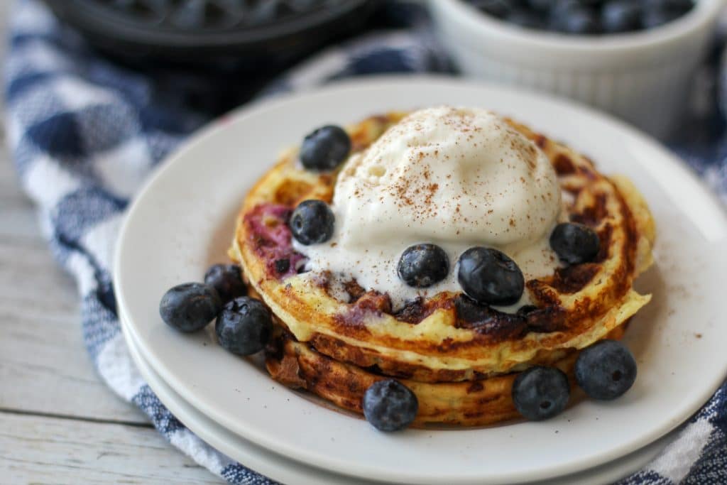 Keto Chaffle recipe with blueberries plated with sugar free ice cream on top 