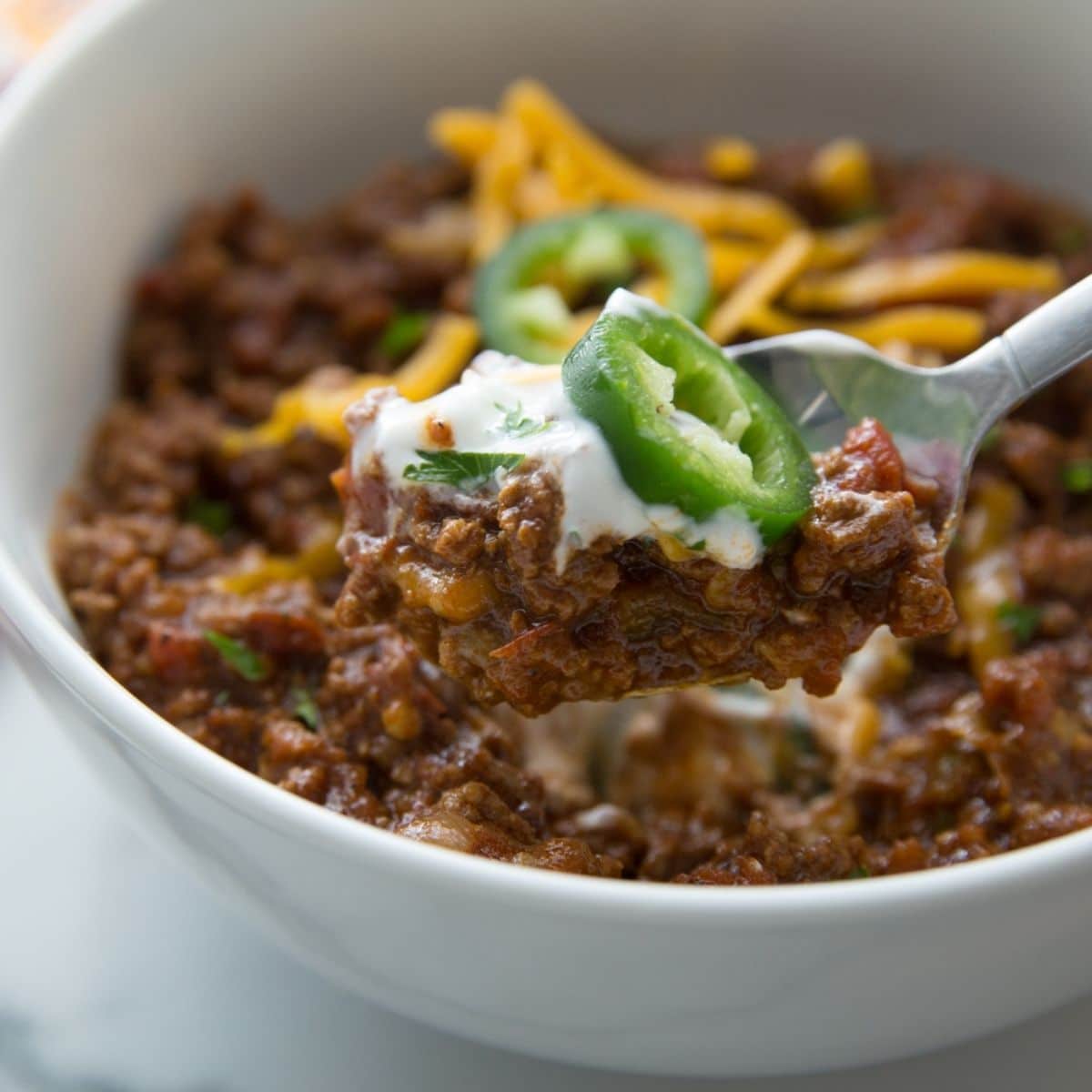 bowl of Keto Chili with shredded cheese on top