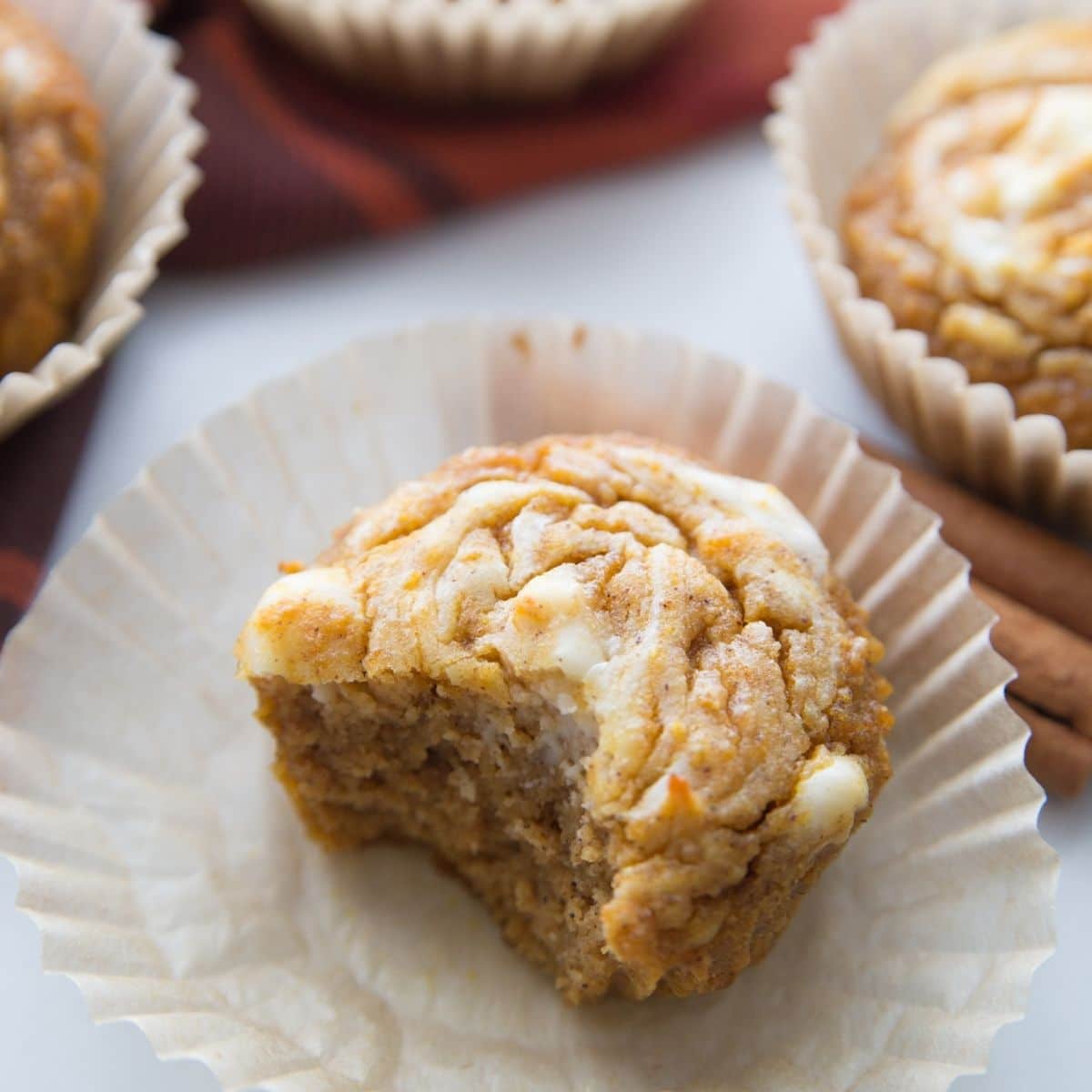 low carb pumpkin cream cheese muffin with a bite taken out of it