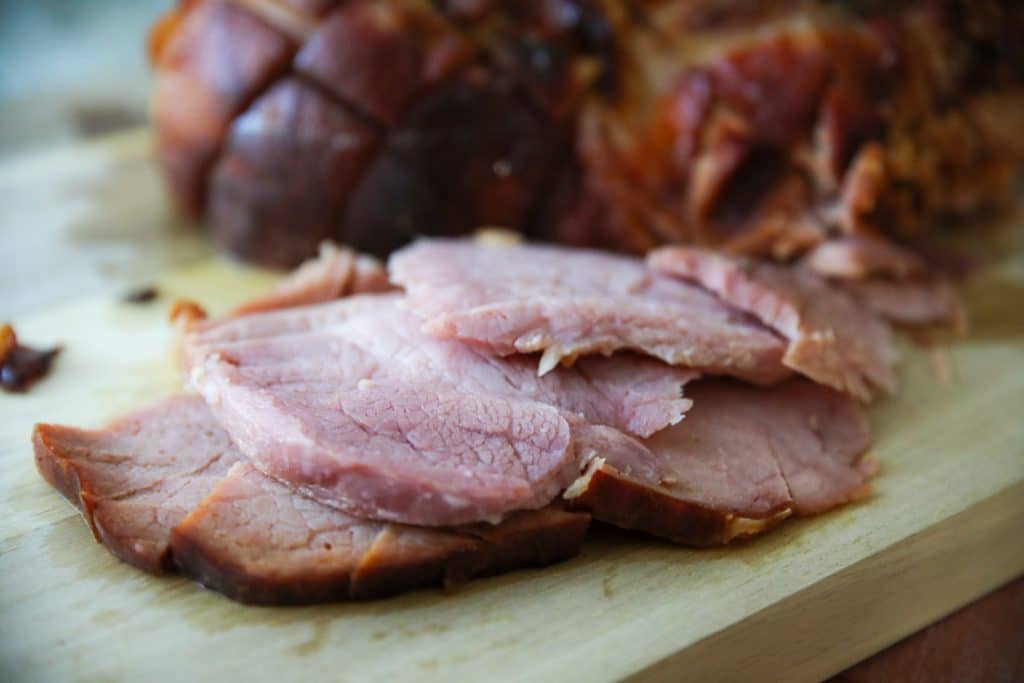 sliced baked keto friendly ham on a cutting board
