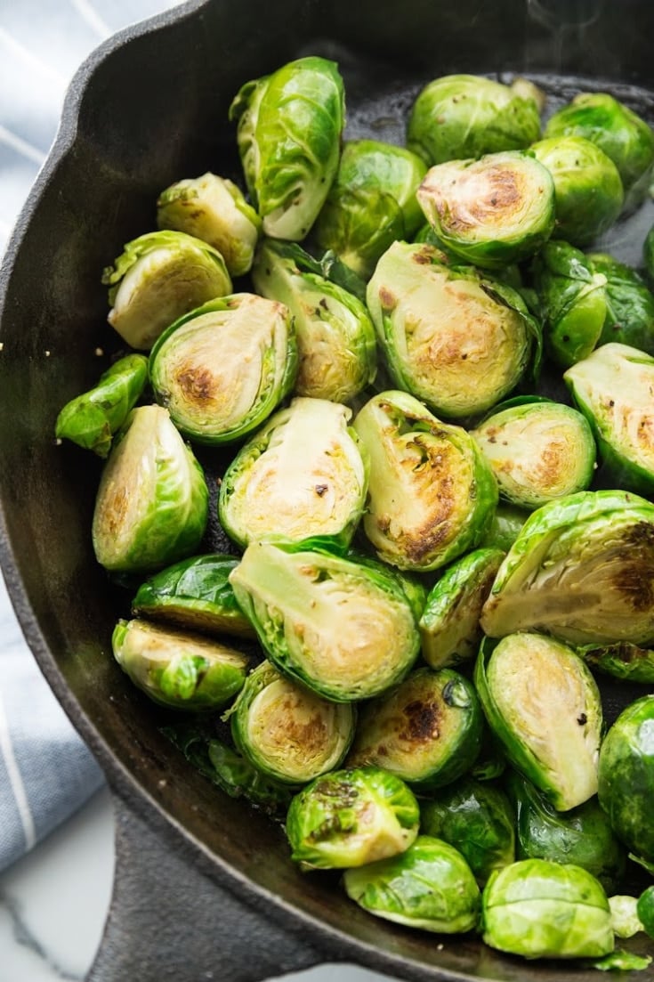 brussels sprouts in a cast iron skillet cut in half roasting