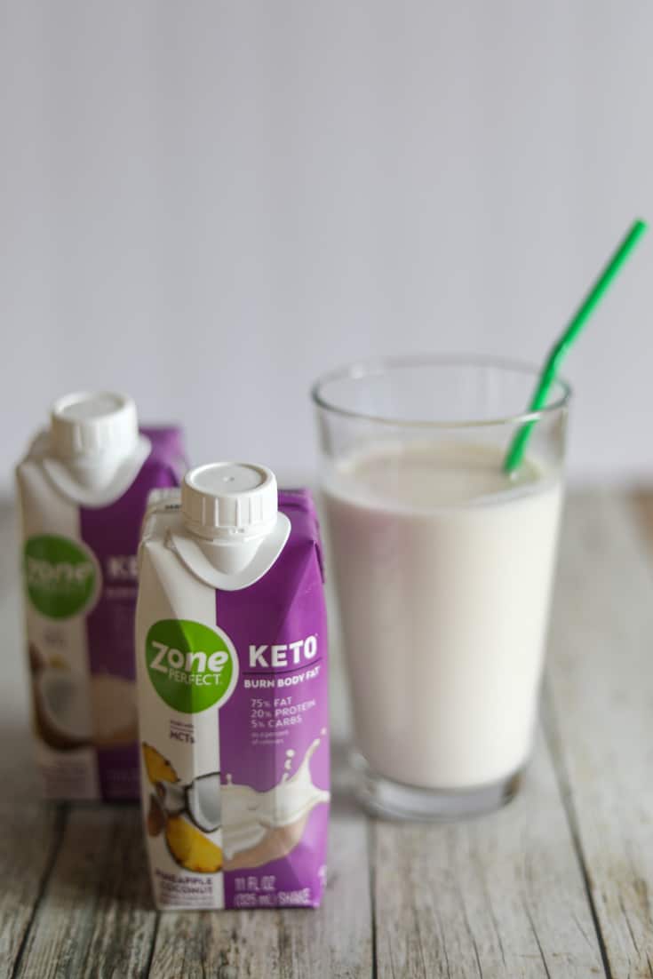 ZonePerfect Keto Shakes poured in a glass with a straw
