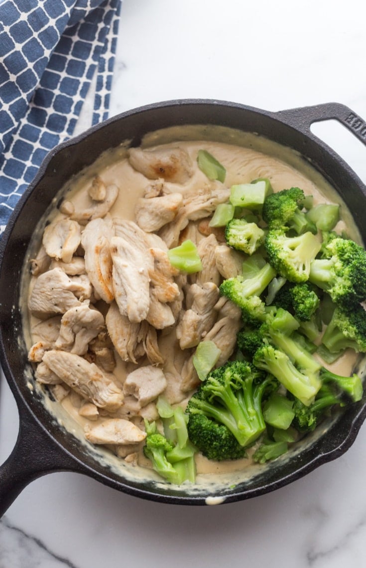 chicken, broccoli, and Alfredo sauce in the skillet