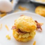 A picture of Keto Low Carb Biscuits on white dish with an egg in the background