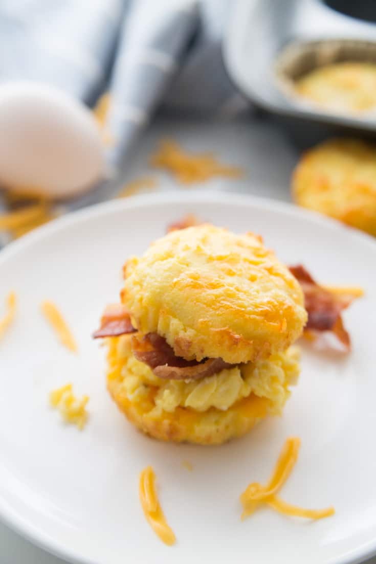 A picture of Keto Low Carb Biscuits on white dish with an egg in the background