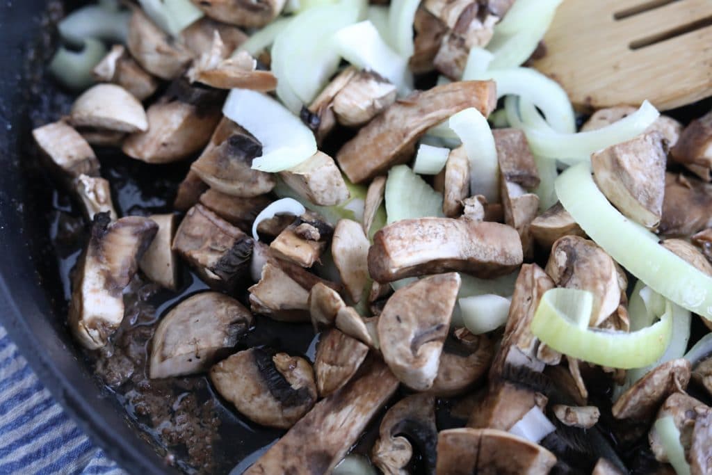 mushrooms and onions in a skillet