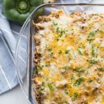 Mexican Taco Casserole in a Dish with green pepper behind it