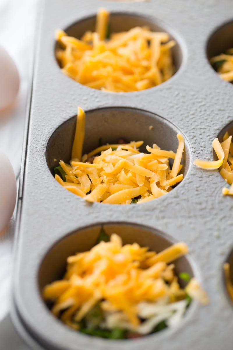 shredded cheese in muffin cups