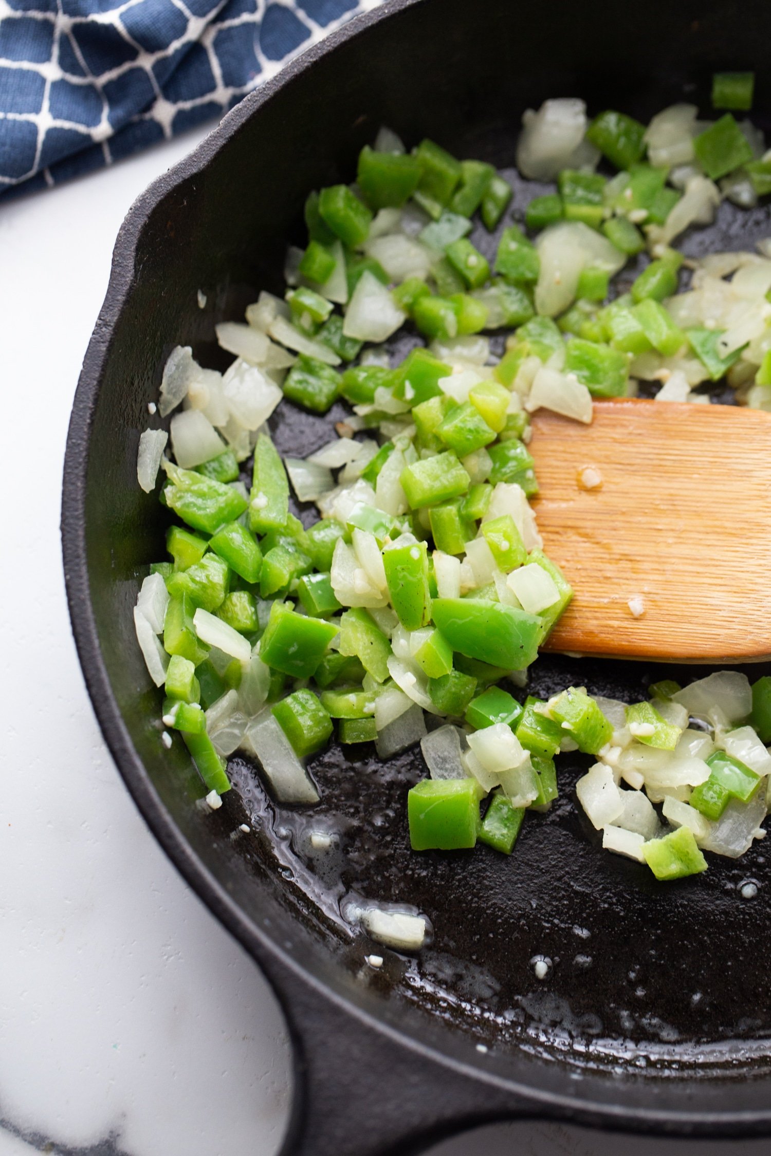 green peppers, onions, and garlic in a cast iron skillet