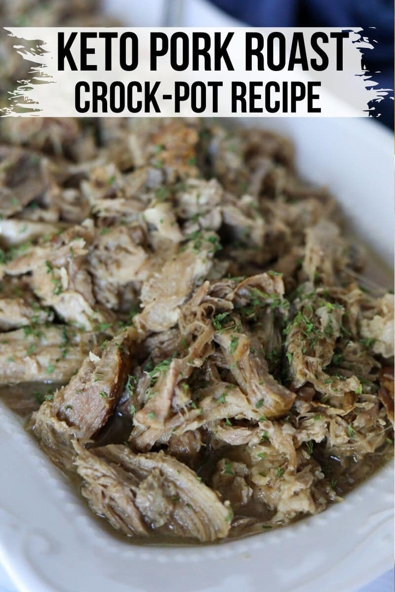 shredded pork roast with herbs in a white baking dish