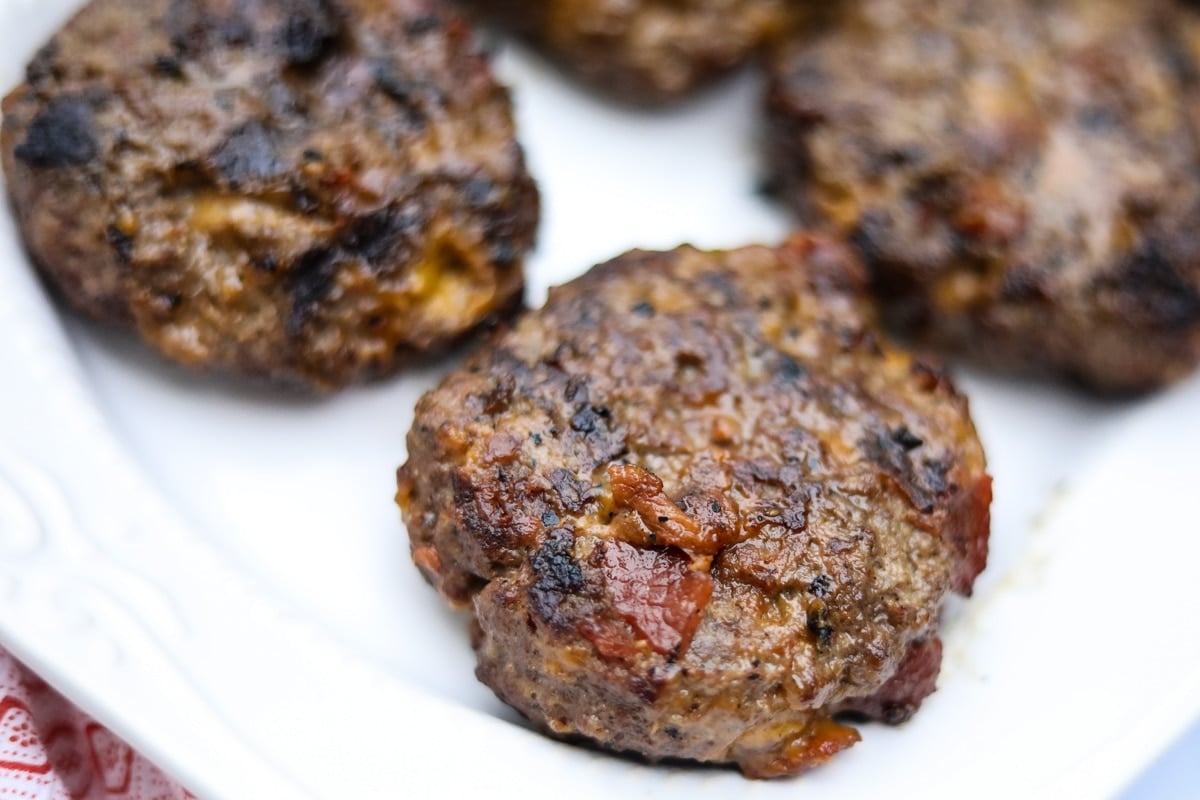 grilled burger patties on white plate