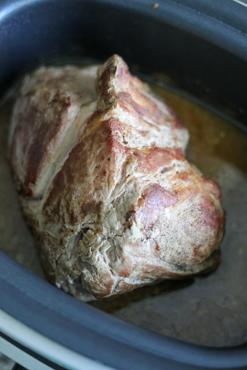 pork butt roasted inside a slow cooker