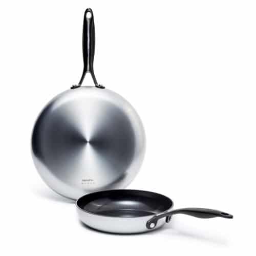 Picture of a Round Cooking Pan with one standing behind it 