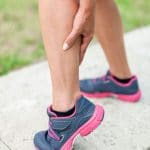 A picture of a Lady holding her leg. Leg cramps on Keto 