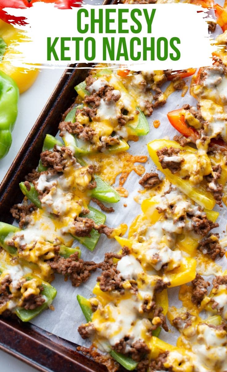 ground beef and cheese on colorful bell peppers on a baking sheet